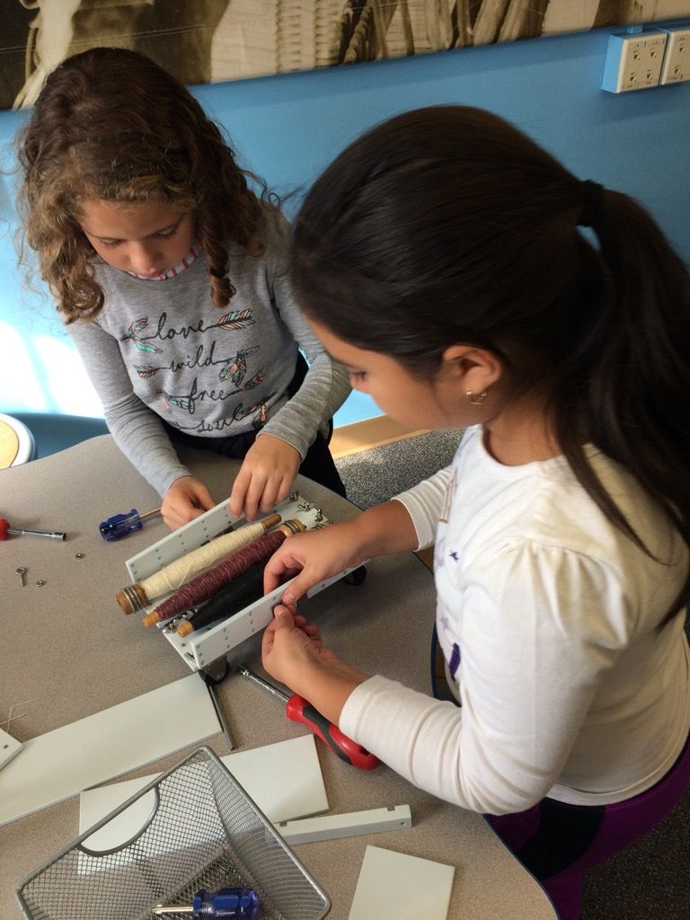 Two girls work on a project at the Tsongas Industrial History Center Two girls work on a project at the Tsongas Industrial History Center
