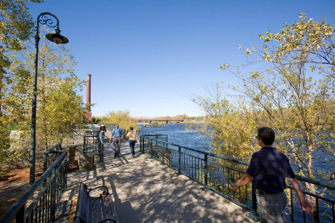 Lowell Riverwalk. People walking.
