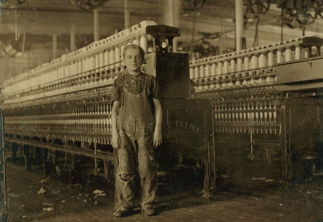 Henry Fourner (a young boy in tattered clothes) working as a sweeper and cleaner in Salem, MA. 1911