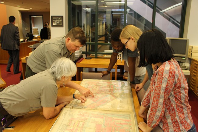 Researchers look at a historic map at the Center for Lowell History
