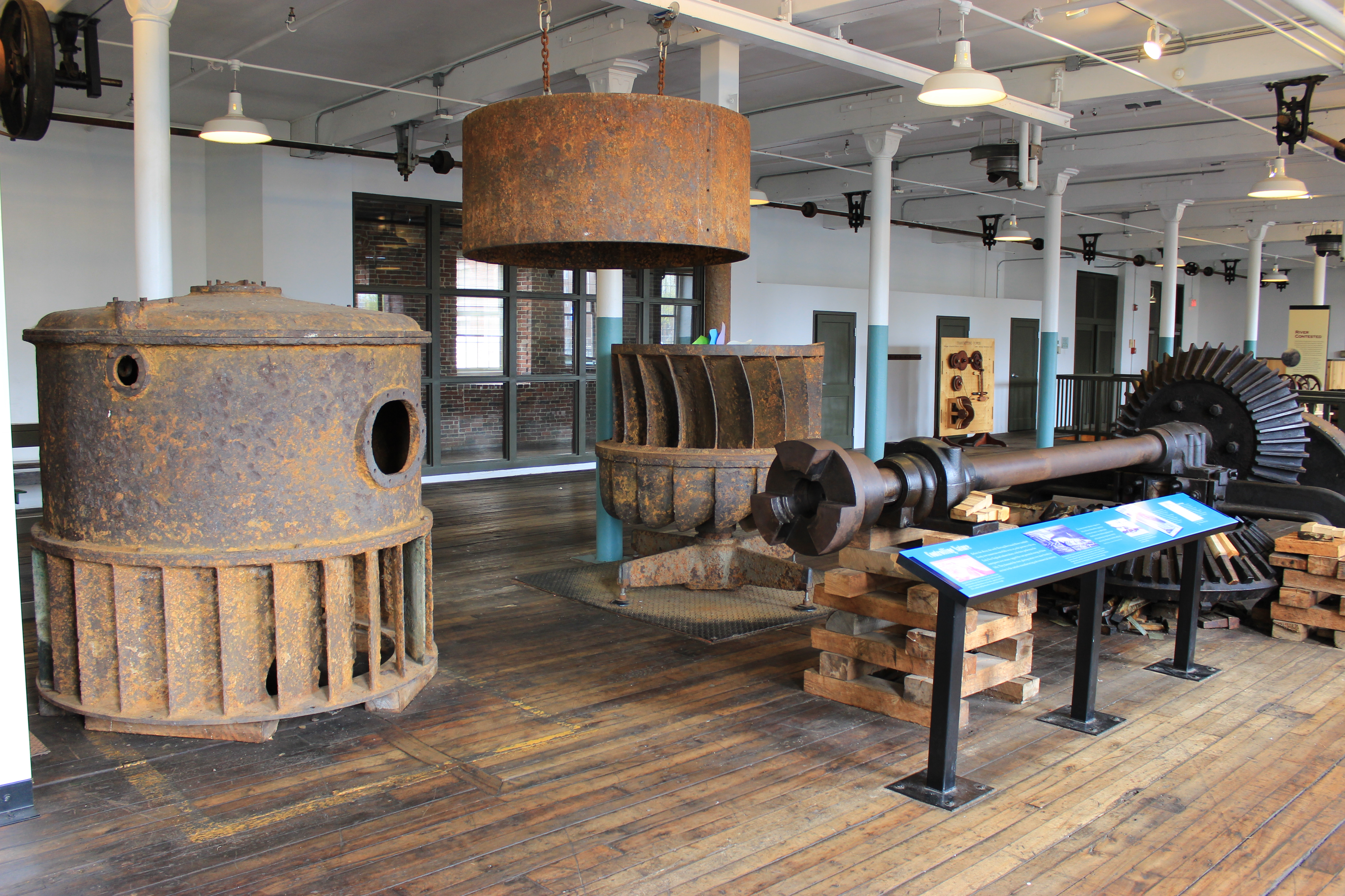 a broken down francis turbine displayed on a historic floor
