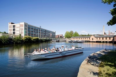 A motor boat full of people on a historic canal