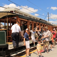 Visitors boarding historic trolleys