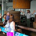 SuffolkTour150 Visitors on tour with a Ranger gesturing to describe the size of a water turbine