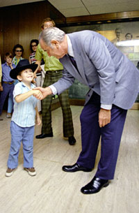 Former Pres. Johnson greets a small boy at the LBJ Library Former Pres. Johnson greets a small boy at the LBJ Library