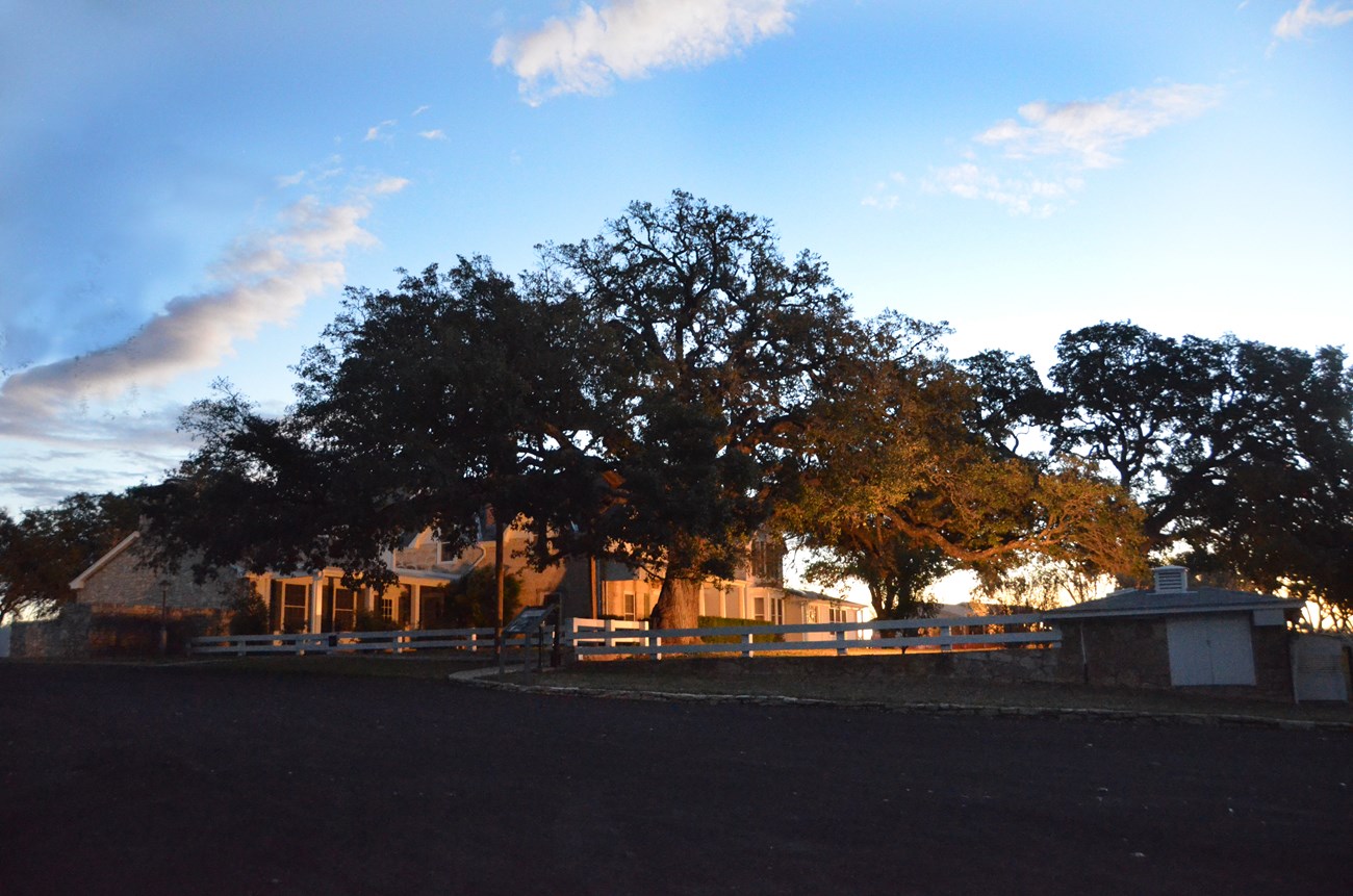 A golden glow lights up the Texas White House in early morning.