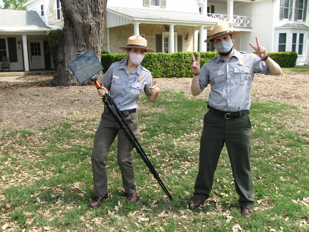 Two Park Rangers holding digital equipment