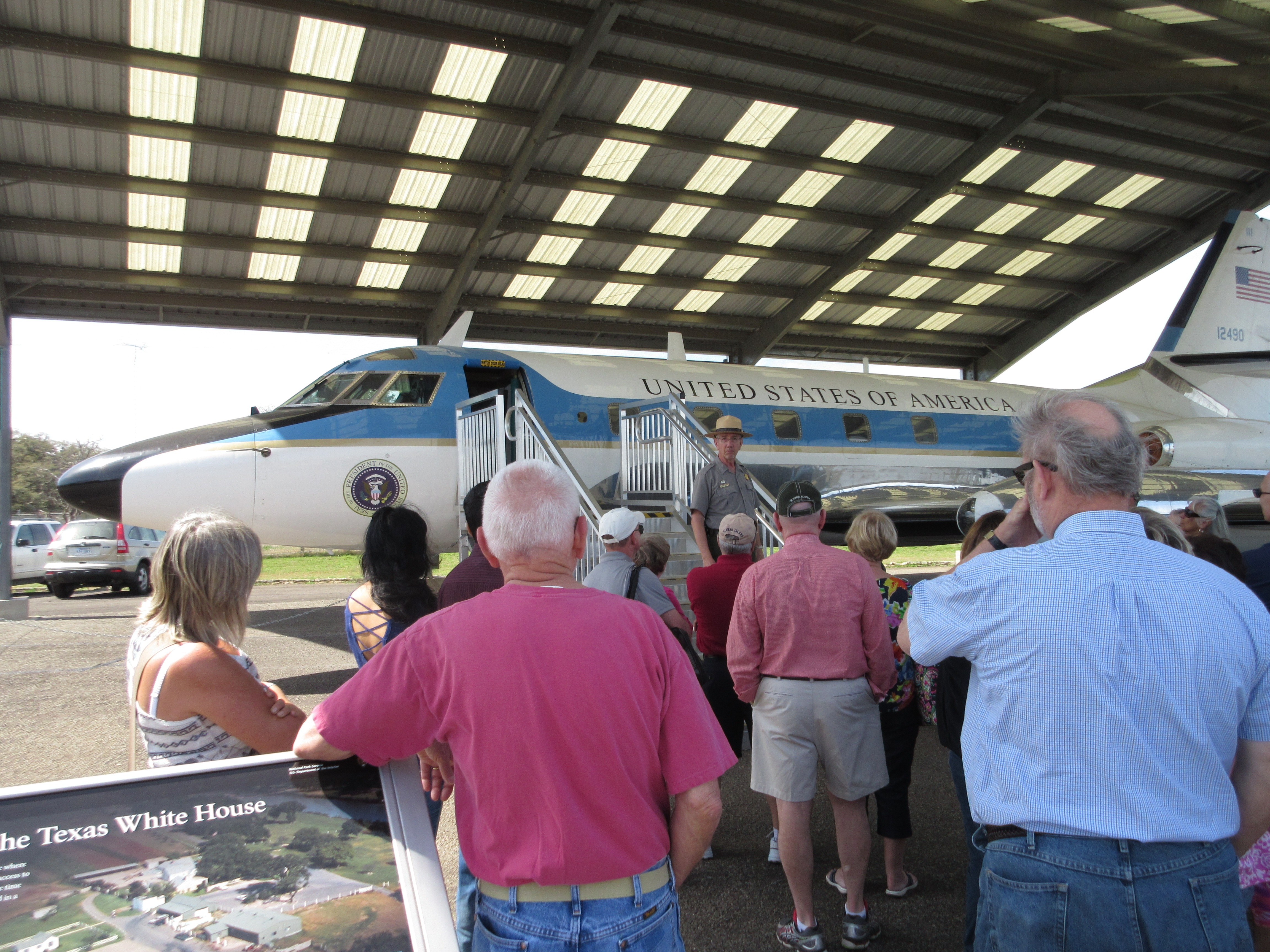 Ranger standing in front of the JetStar, talking to a group of visitors