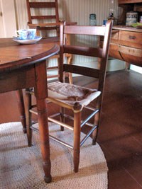 The Birthplace's original rawhide chair.  Mrs. Johnson's Roycrafter high chair is in the background.