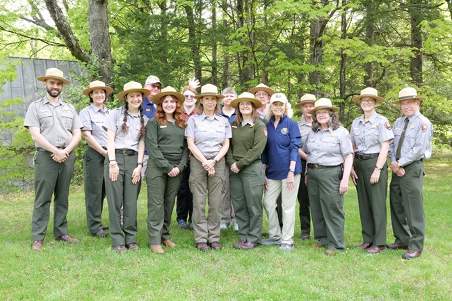 group of 15 people, park rangers and volunteers, pose for photo outdoors