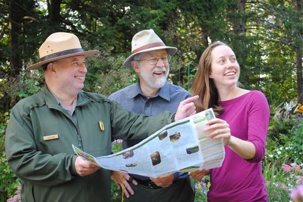 Two Rangers with park employee and map