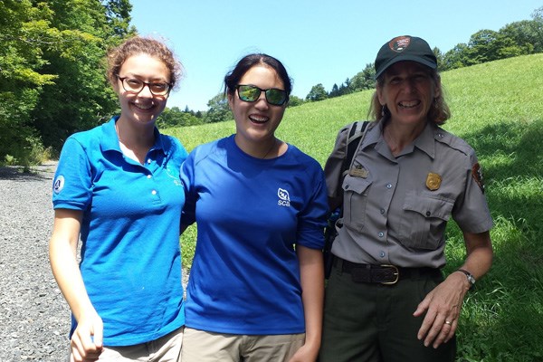 Interns and Ranger on trail in summer 600x400