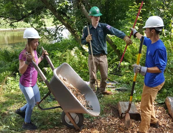 3 Interns working in the park