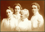 This sepia-toned photograph from the end of the 19th century depicts an elderly Julia Parmly Billings surrounded by her three dark-haired daughters, all four wearing high-collared white dresses.