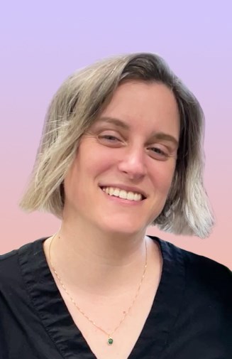 headshot of person smiling at camera with short blonde hair