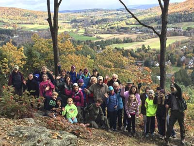 Group of hikers on top of south peak overlooking Woodstock Vermont