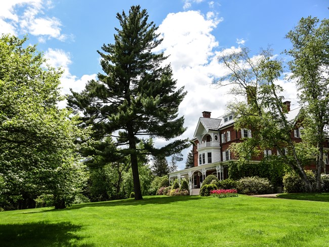 Distant view Marsh Billings Rockefeller Mansion with lawn in foreground