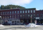 A three-story brick building lines the downtown streets of Woodstock.