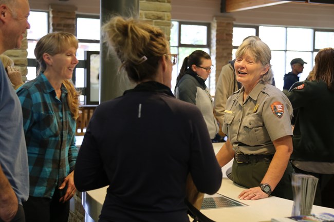 A park ranger answering visitor questions.