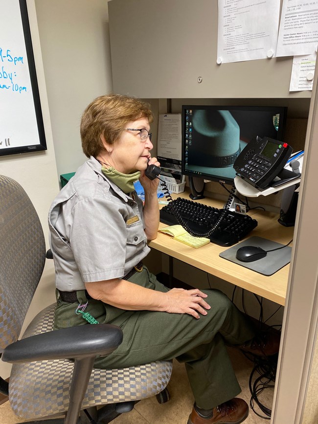 A park ranger on the phone