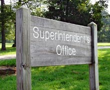 A grey, weathered wood sign for the Superintendent's Office. A grey, weathered wood sign for the Superintendent's Office.