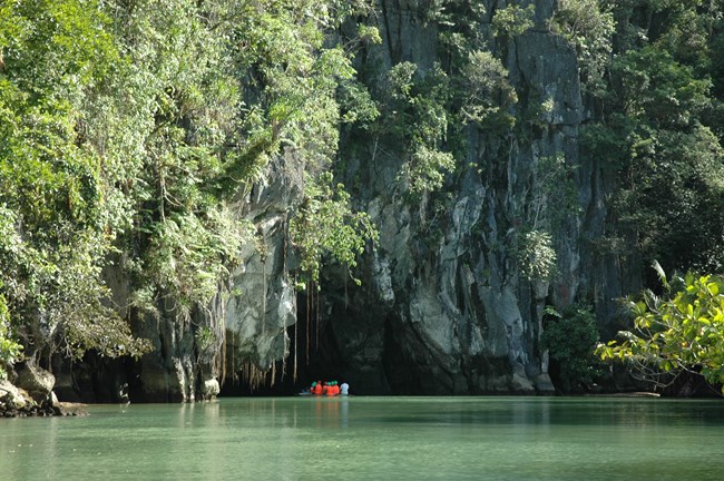 A boat entering a cave from a large body of water