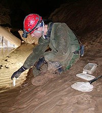 Researcher testing cave waters Researcher testing cave waters