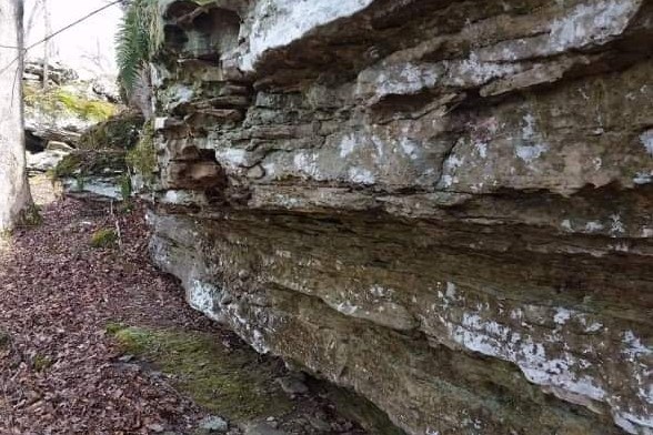 A rock outcropping on the surface showing several rock layers.