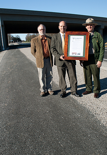 Park City Mayor David Lyons and Mammoth Cave NP Acting Superintendent Bruce Powell present a proclamation of appreciation to Greg Merideth of KYTC along the new section of bike trail that connects Park City to the national park.