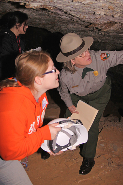 Ranger shows teacher-students differences in gypsum formations - why do gypsum crystals sugar-coat the cave walls in one place and jut out in curls in another?
