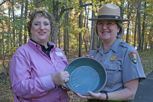 Dr. Jeanine Huss (left) presents the KAEE traditional award, a Kentucky-made spoonbread bowl, to Cheryl Messenger who was named Environmental Education Individual of 2010, the highest individual honor bestowed by the statewide organization.