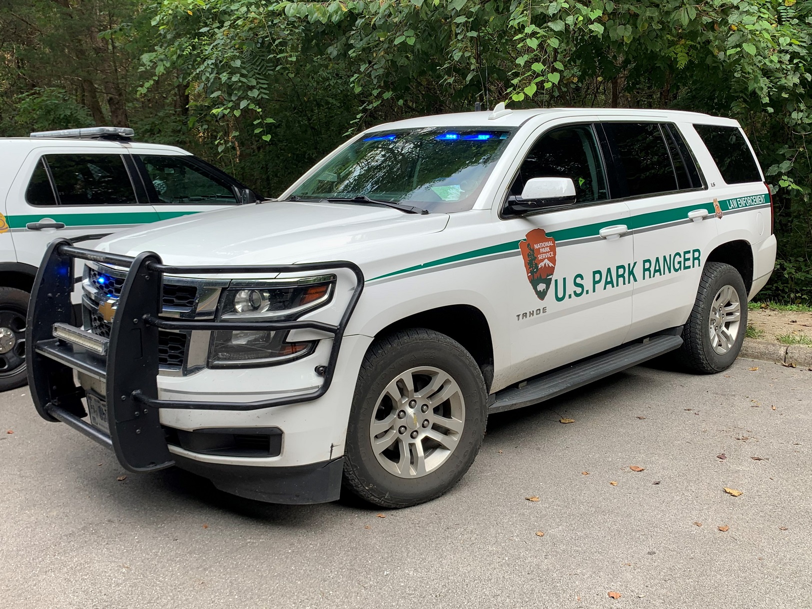 A white Chevy Tahoe with U.S. National Park Service Law Enforcement written in green on the side.