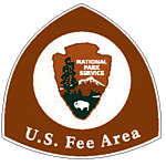 A brown US Fee Area sign