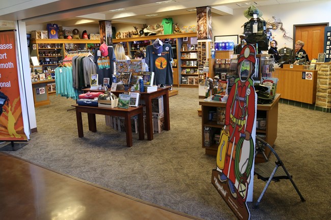 Racks of clothes and shelves of books and games about Mammoth Cave are displayed for visitors to purchase.