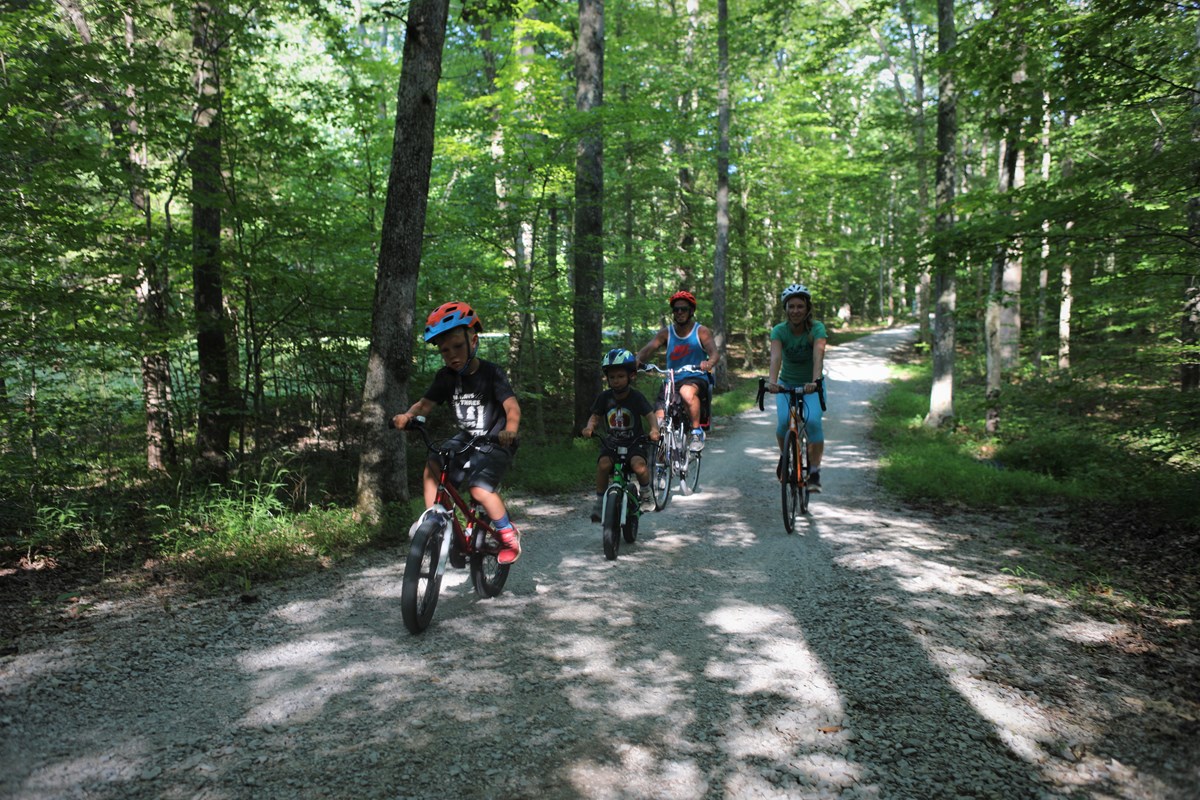 A family riding bikes along a trail