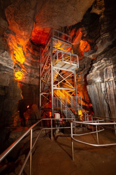 Seven flights of metal stairs ascending to the cave ceiling.