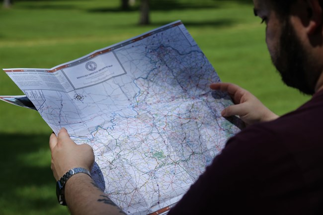 A visitor looking at a Kentucky highway map