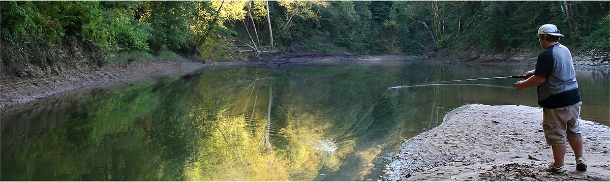 A young man fishing in Green River at Mammoth Cave National Park