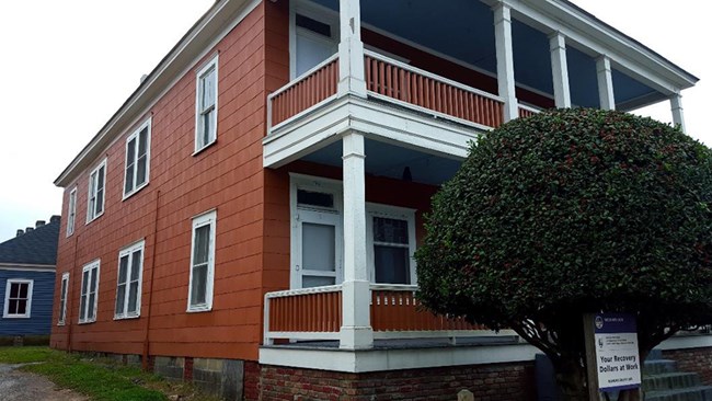 Exterior of dark orange quadruplex structure with white trim located on the same residential block as the Birth Home of Martin Luther King, Jr.