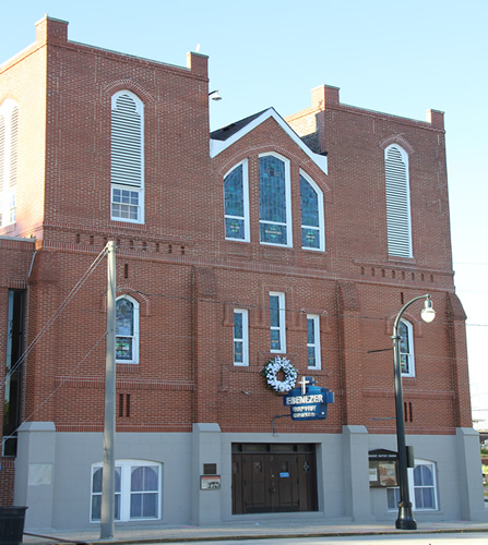 A wreath on the exterior of Ebenezer Baptist Church, Heritage Sanctuary. A wreath of white flowers on the exterior of Historic Ebenezer Baptist Church, Heritage Sanctuary.