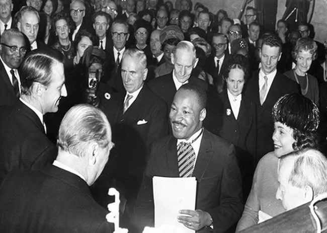 Dr. Martin Luther King, Jr. shakes hand of King Olav of Norway at prize ceremony in Oslo.