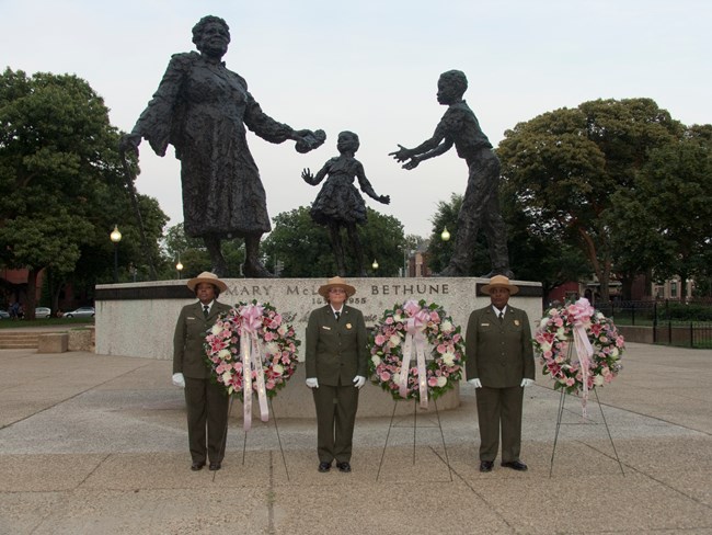 Park Rangers lay wreaths before the Mary McLeod Bethune Memorial during a Birthday event