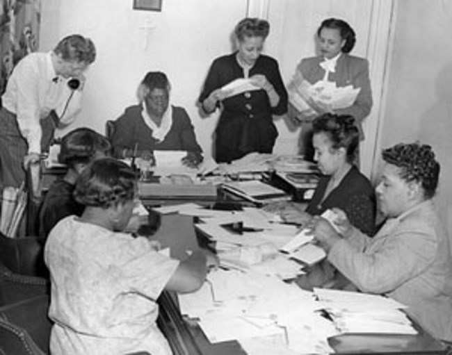 Bethune Council Women Bethune and her council members sitting at a desk going through paper work