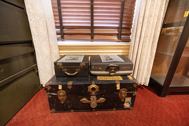 Black suitcases sit in the secretary's office on the second floor of the home.