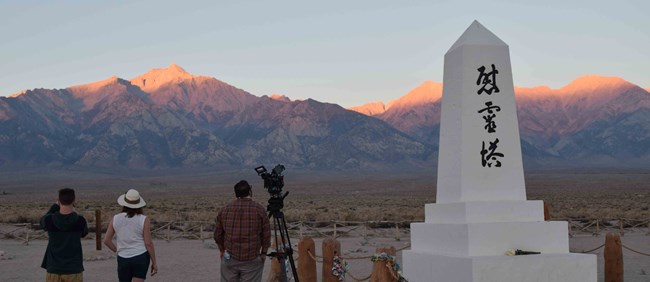 People and sunrise at the cemetery People and sunrise at the cemetery