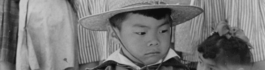 Little boy watches Memorial Day services. Photo by Francis Stewart.