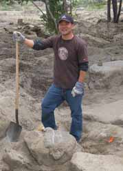 Young man with a shovel helping to dig out Merritt Park.