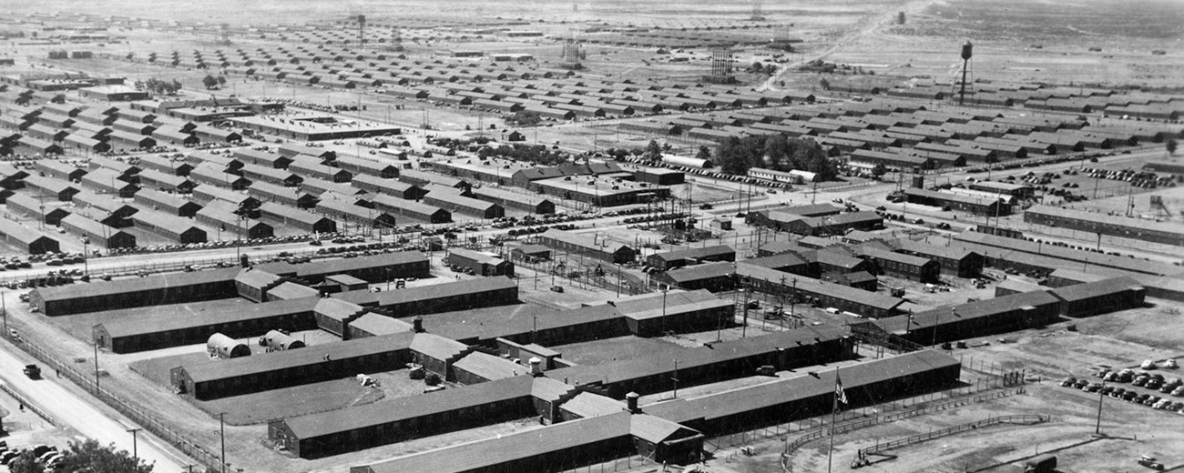 Black and white photo of rows upon rows of narrow buildings.