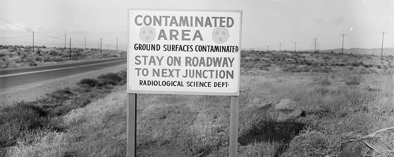 Sign at Hanford A sign on a desert road reads “Contaminated Area. Ground Surfaces Contaminated. Stay on Roadway to Next Junction. Radiological Science Dept.”