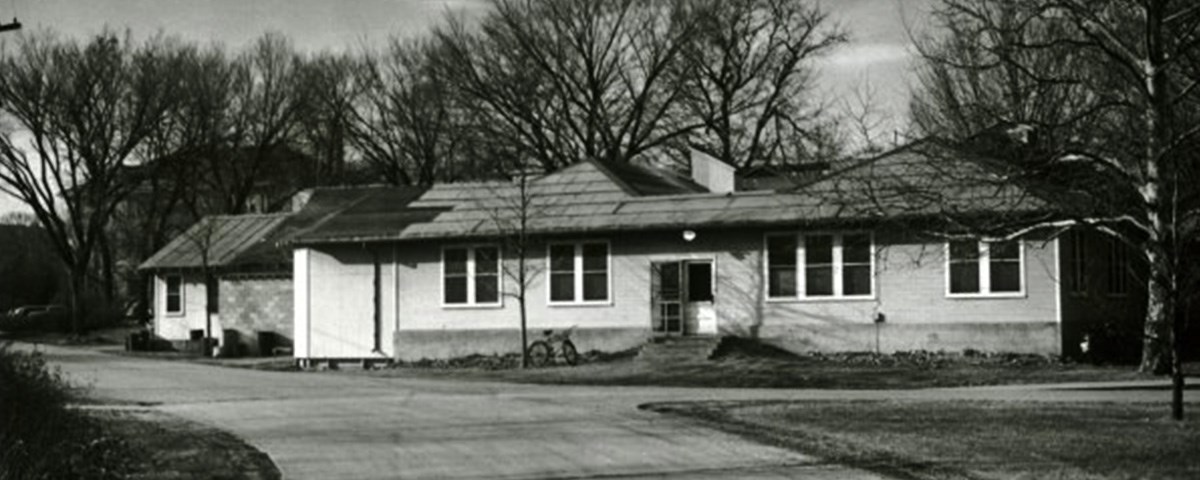 A black and white photo of a white, horizontal building.
